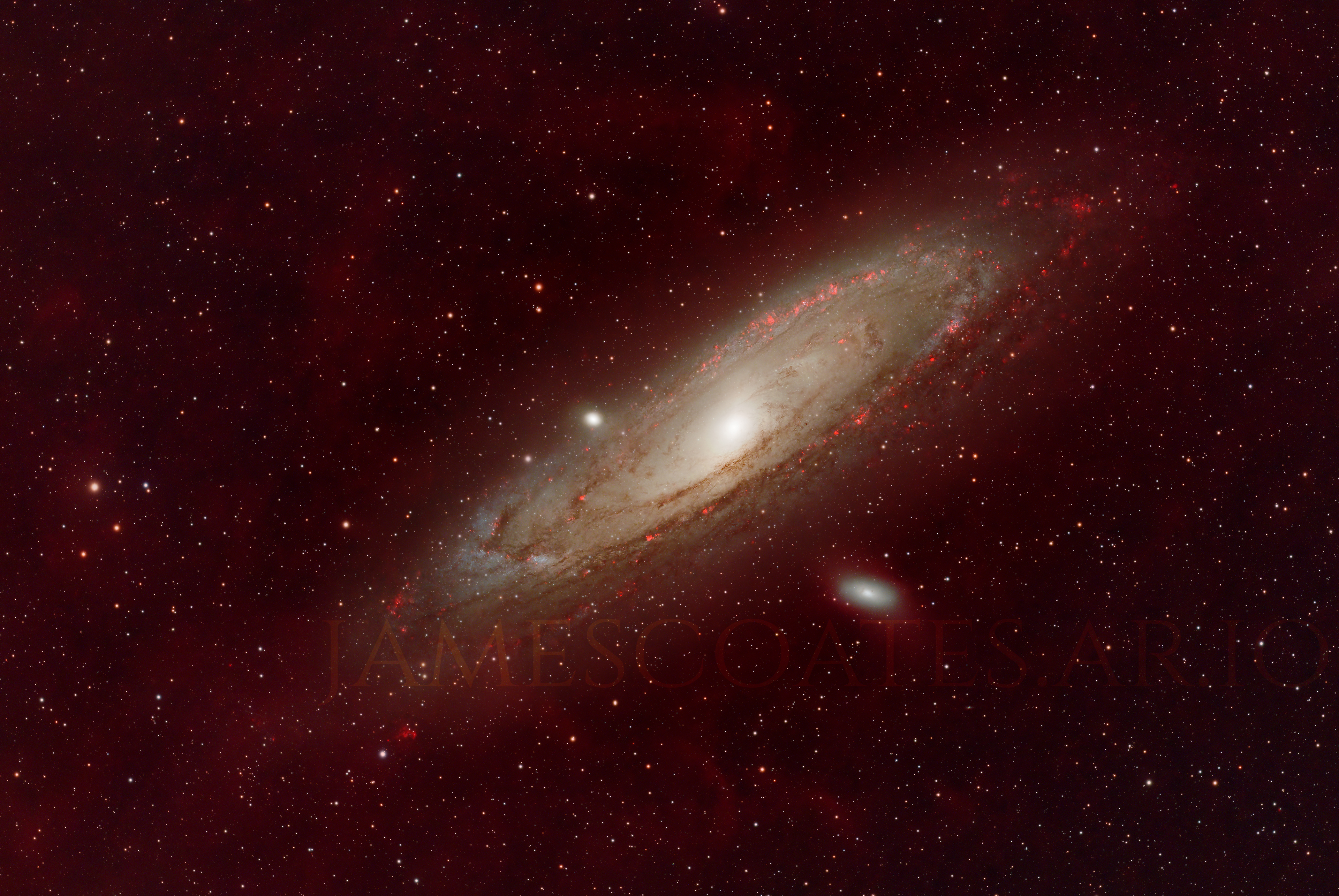 The Andromeda Galaxy imaged with a hydrogen-alpha filter, the star forming regions in its arms showing red